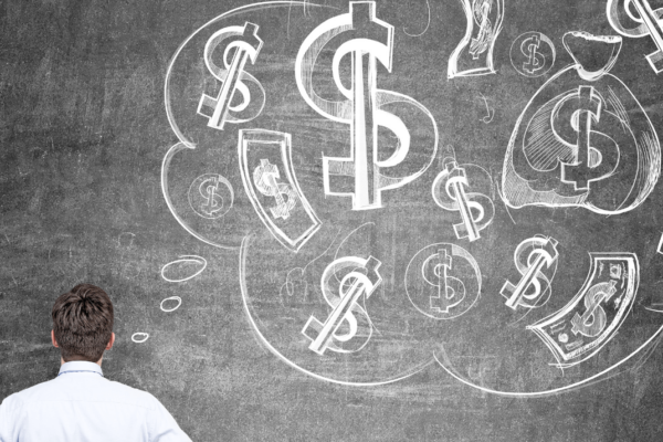 a man looking at a chalkboard with dollar signs thoughts indicating money psychology