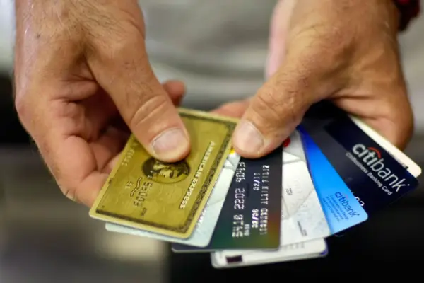 a person holding credit cards indicating credit card rewards